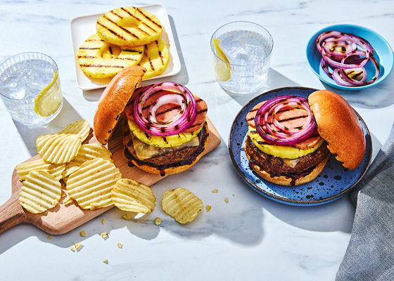 Two tropical burgers topped with pineapple