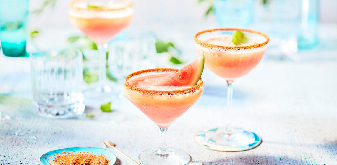 Three watermelon beergaritas in margarita glasses.