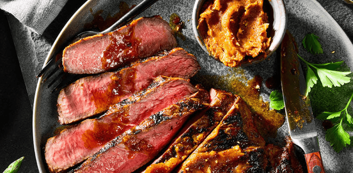 Sliced grilled top sirloin topped with butter.