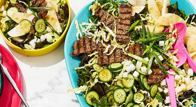 Three portions of bulgogi smashed burger salad on a marbled surface.