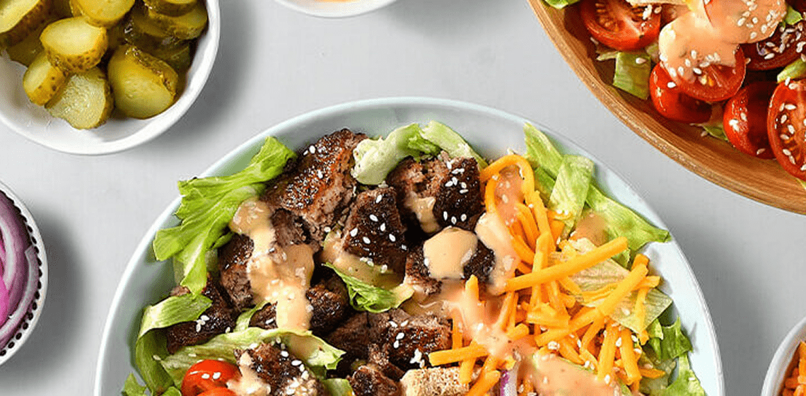 Loaded burger salad in grey bowl