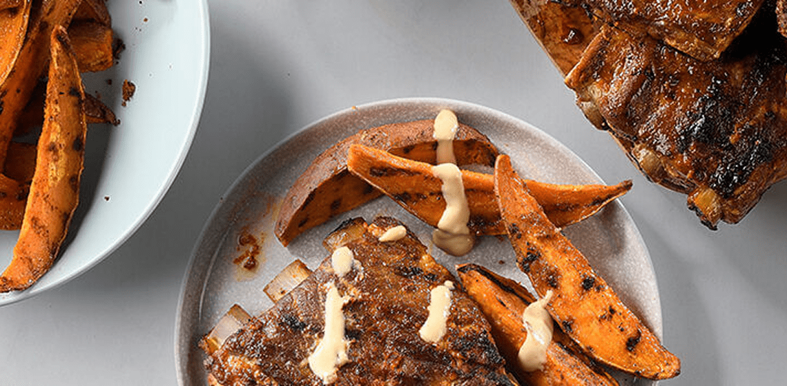 Roasted garlic and red pepper side ribs with a side of sweet potatoes
